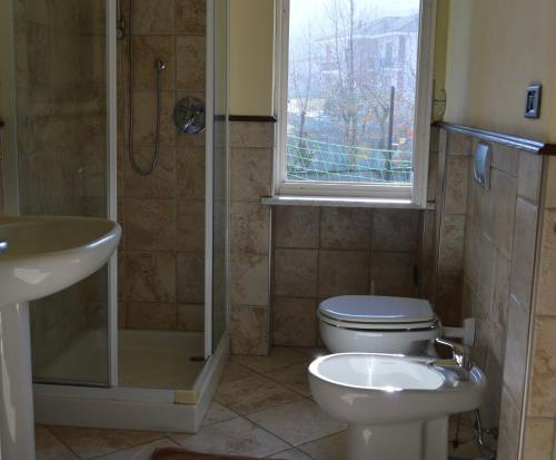 a bathroom with a toilet and a sink and a shower at Il Borgo in Sanfront