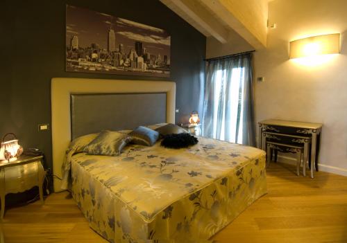 a bedroom with a large bed and a piano at Malpassuti Resort in Carbonara Scrivia