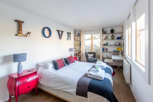 a bedroom with a bed and a desk and a sink at Boat Lake in Thorpeness