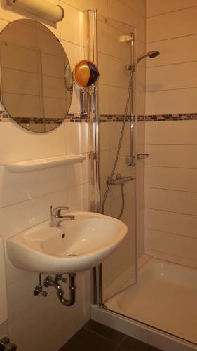 a bathroom with a sink and a shower at Gästehaus "Am weißen Stein" in Cochem