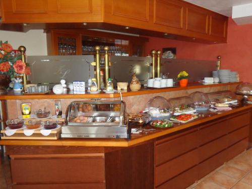 a kitchen with a buffet of food on a counter at Hotel Zur Lohe in Merzenich
