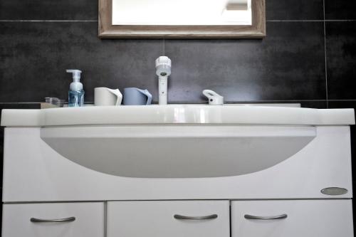a white sink in a bathroom with a mirror at The Great Wall Box House - Beijing in Miyun