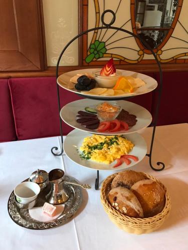 a three tiered tray of food on a table at Hotel Ovo malo duše in Sarajevo