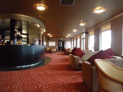 a hotel lobby with couches and a bar at Pitbauchlie House Hotel - Sure Hotel Collection by Best Western in Dunfermline