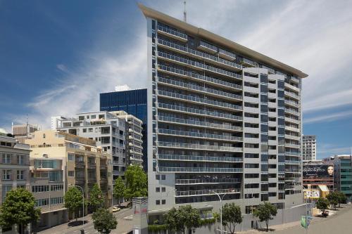 a tall building in a city with buildings at The Chancellor on Hobson in Auckland
