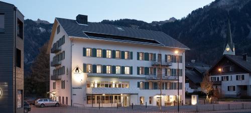 a large building with a large window on top of it at Hotel Bären in Mellau