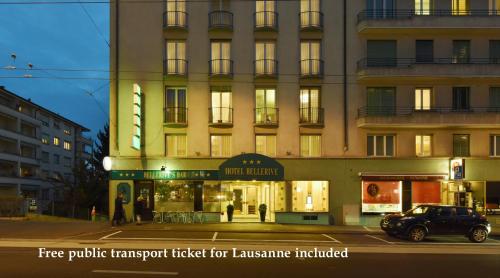 a large building with a car parked in front of it at Hôtel Bellerive in Lausanne