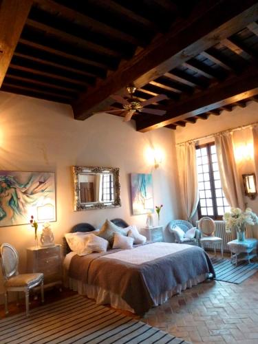 une chambre avec un grand lit dans une pièce dans l'établissement Les Saisons, à Villeneuve-lès-Avignon