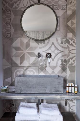 a bathroom with a sink with a mirror and towels at 18 Micon Str. in Athens