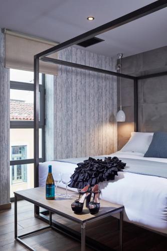 a bedroom with a bed and a table with shoes on it at 18 Micon Str. in Athens