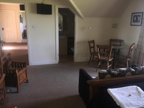 a living room with a couch and a table and chairs at The Curragh Country House Accommodation in Newbridge