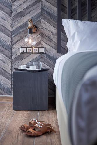 a bedroom with a bed and a side table with sandals at 18 Micon Str. in Athens