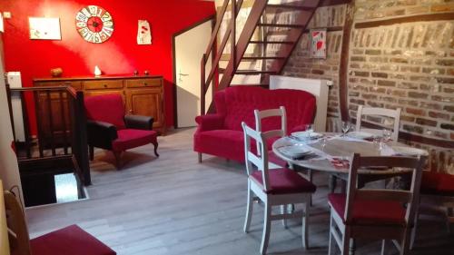 デュルビュイにあるLe poirier de Warreのダイニングルーム(テーブル、赤い椅子付)