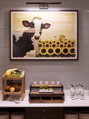 a picture of a cow in a field of flowers at Best Western Plus Vauxhall Hotel in London