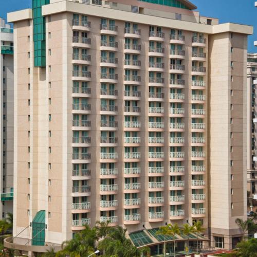 a tall white building with many windows at Bourbon Residence Barra da Tijuca - Rio de Janeiro in Rio de Janeiro