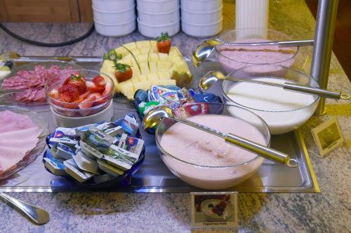 a tray of food with fruit and other foods on a counter at Hôtel Bellerive in Lausanne