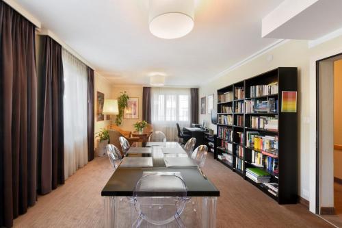 a living room with a long table and chairs at Hôtel Bellerive in Lausanne