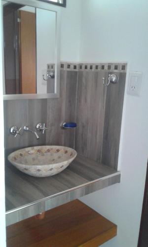 a bathroom sink with a large bowl on a shelf at Isabel in Alta Gracia
