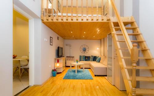 a loft apartment with a staircase and a living room at Souper Apartments Downtown-Király Street in Budapest