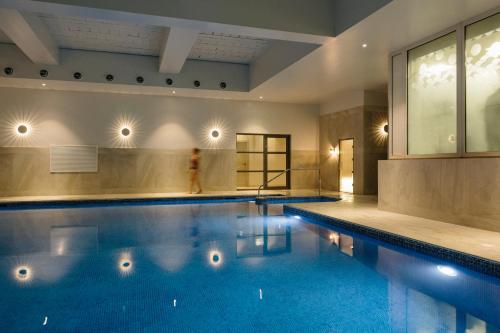 a large swimming pool in a building with at Merchants Manor Spa in Falmouth
