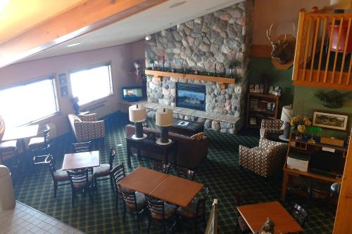 a living room filled with furniture and a tv at AmericInn by Wyndham Iron River in Iron River