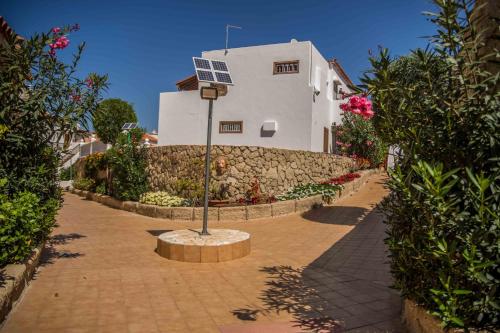 a building with a street light in the middle of a sidewalk at Apartment Paraiso Royal in Playa de las Americas