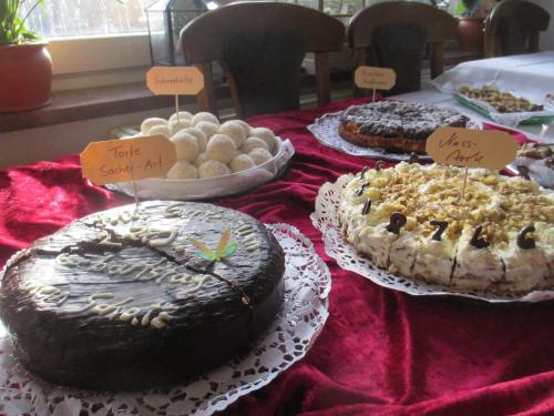 a table topped with cakes and other desserts on plates at Adler Golf-& Tagungshotel in Harth - Pöllnitz