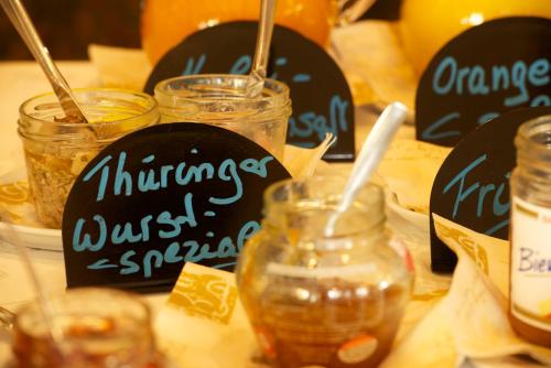 a table with jars of food and signs on it at Adler Golf-& Tagungshotel in Harth - Pöllnitz