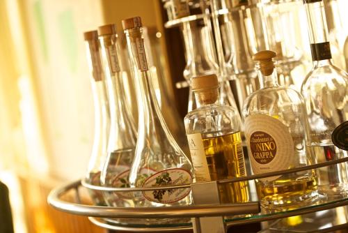 a metal shelf with bottles of alcohol on it at Adler Golf-& Tagungshotel in Harth - Pöllnitz