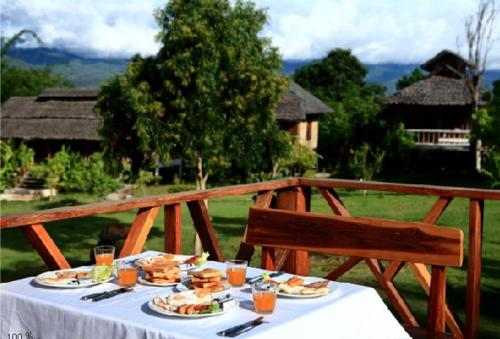 a table with plates of food on top at Pai Love & Baan Chonphao Resort in Pai