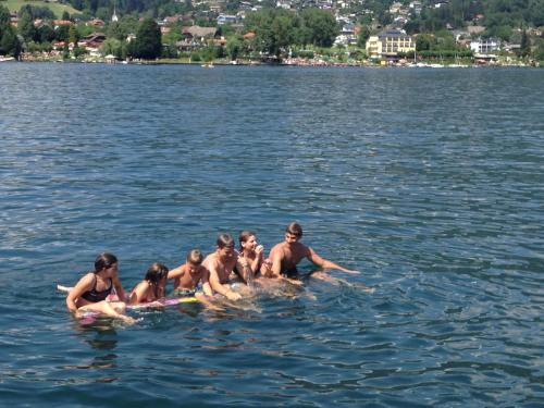 a group of people standing in the water at Waldstrand Berger in Seeboden