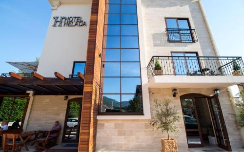 a facade of a building with a restaurant at Hotel Helada in Tivat