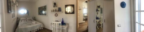 a room with a bedroom with a bed and a mirror at La Casa di Nina in La Maddalena