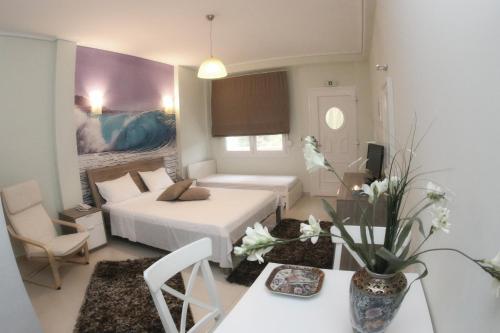 a small room with a bed and a table with a table sidx sidx at Studios Ioulia in Keramot&iacute;