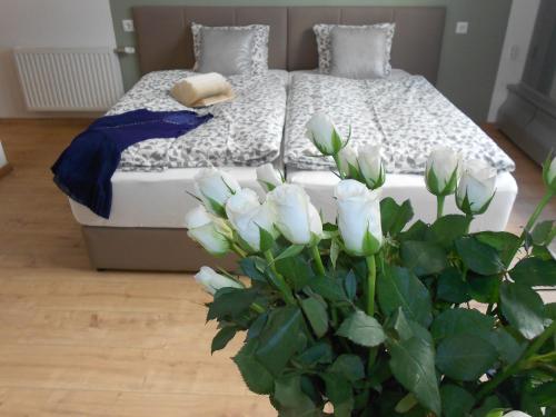 a bedroom with a bed and a plant with white flowers at Dan In'n Out in Vienna