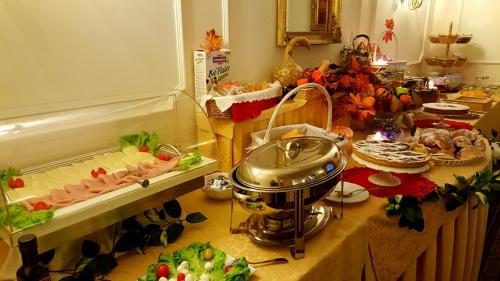 a table with a buffet of food and a buffet at Hotel Royal in Bolsena