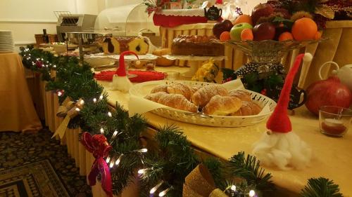 a table with pastries and christmas decorations on it at Hotel Royal in Bolsena