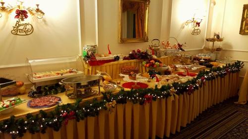 a table with food and christmas decorations on it at Hotel Royal in Bolsena
