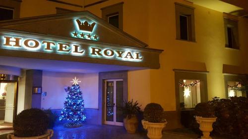 a hotel lobby with a christmas tree in front of it at Hotel Royal in Bolsena