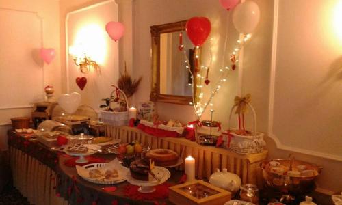 a table filled with food and balloons and candles at Hotel Royal in Bolsena