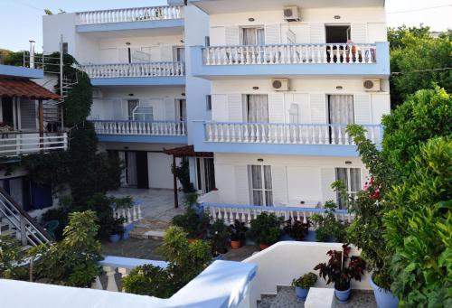 an apartment building with balconies and trees at Ilias Studios - Rooms in Patitiri
