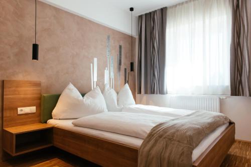 מיטה או מיטות בחדר ב-Aparthotel Heuberger