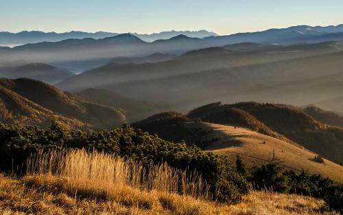 a hillside with a view of a valley with mountains at Chata Horec in Liptovské Revúce