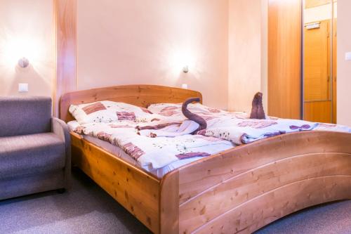 A bed or beds in a room at Horský Hotel Kristína