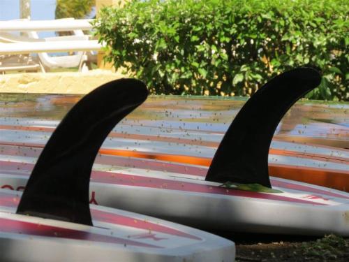 a bench with a pair of surfboards on it at Beach Break Resort & CR Surf Camp in Jacó