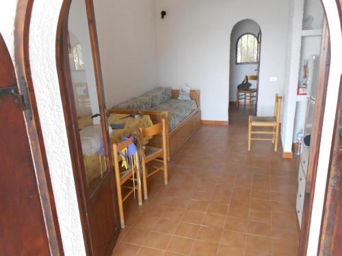 a living room with a couch and a table and a mirror at Casa a Calacreta in Lampedusa