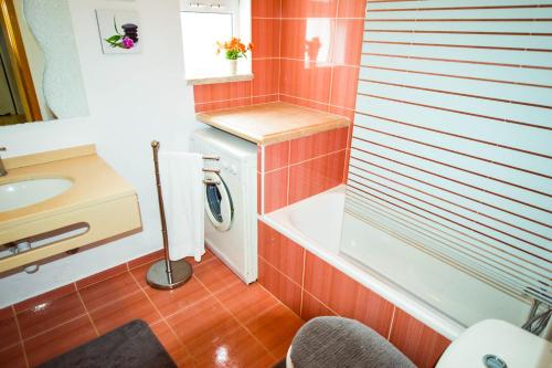 a bathroom with a sink and a washing machine at Algarpraia in Carvoeiro
