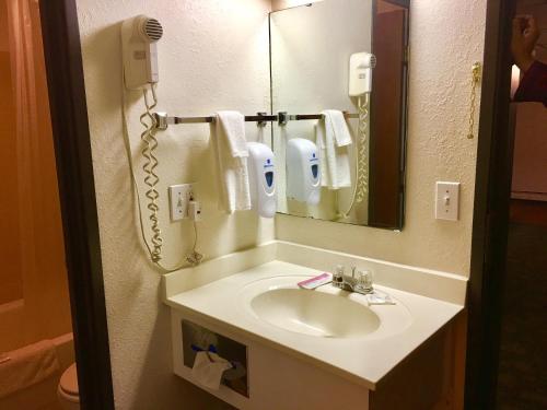 a bathroom with a sink and a mirror at Select Inn Breckenridge in Breckenridge