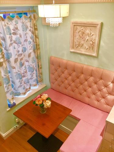 a living room with a couch and a table at Angel's (station accommodation) in Cambridge