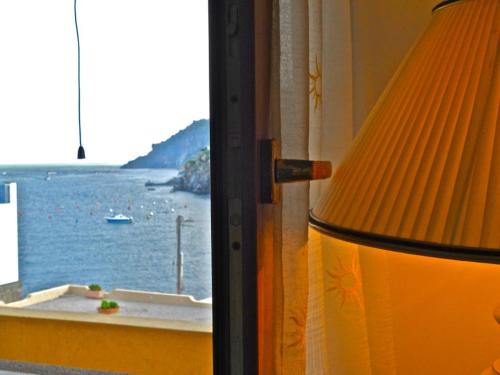 a room with a window with a view of the ocean at Casa vacanze Lipari da Sergio spiaggia sotto casa in Lipari